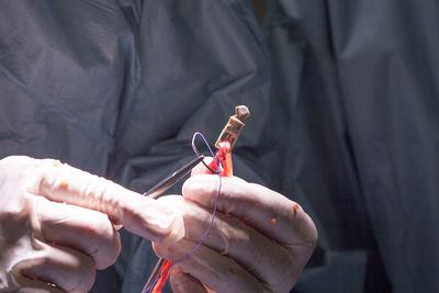 Midsection of doctor performing surgery at hospital