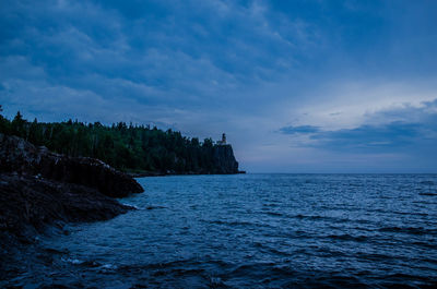 Scenic view of sea against cloudy sky