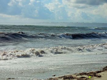 Scenic view of sea against cloudy sky
