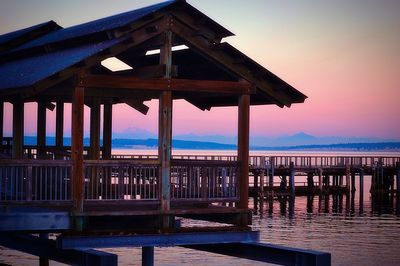 Pier on sea at sunset