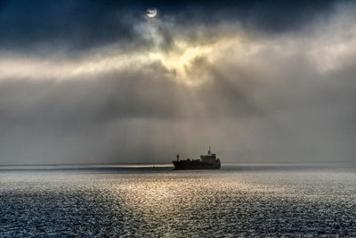 Boat sailing in sea against sky