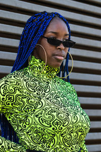 Portrait of woman wearing sunglasses standing outdoors