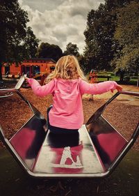 Rear view of girl in playground