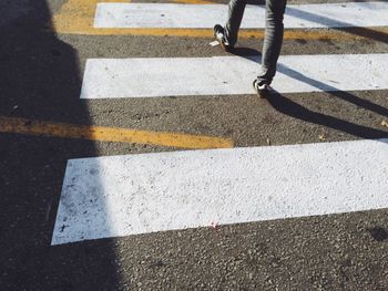 Low section of people walking on road