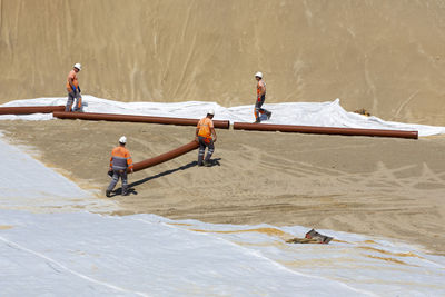 High angle view of people working on beach