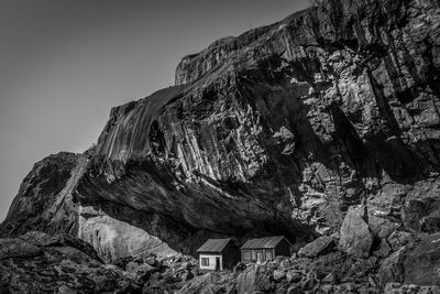 Low angle view of historical houses and mountain against sky