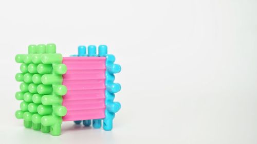 Close-up of multi colored candies against white background