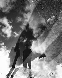 Rear view of man standing against sky