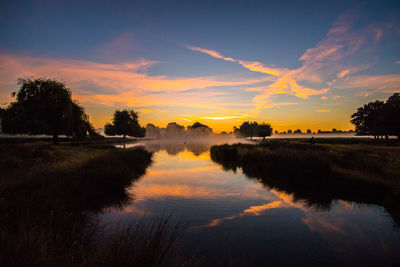 Scenic view of lake at sunset