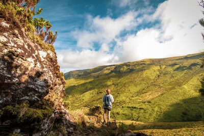 Azores islands, landscape with hiker in green vegetation, flores, travel destination for hiking.