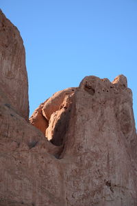 Low angle view of rock formations against sky