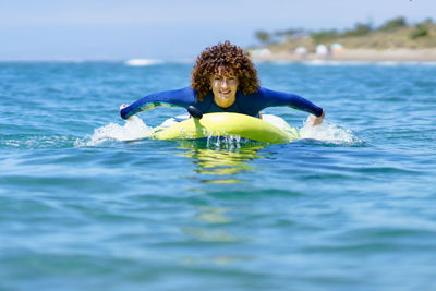 Young woman swimming in sea