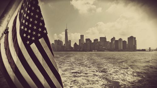 Panoramic view of sea and buildings against sky