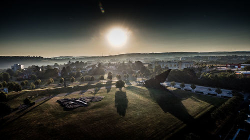 Aerial view of city against sky during sunset