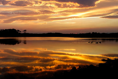 Scenic view of lake against sky during sunset