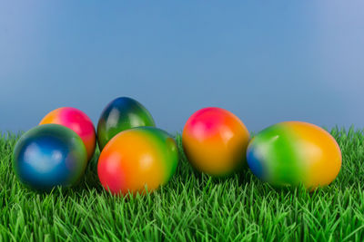 Close-up of multi colored eggs on grass