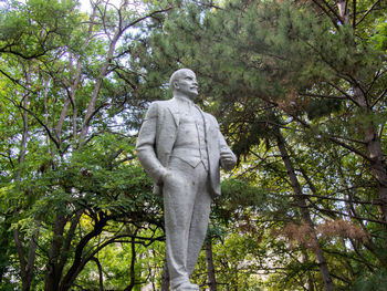 Low angle view of statue against trees in park