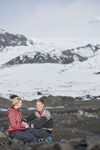 Young couple having a picnic in barren landscape in iceland