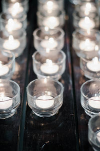 Close-up of illuminated candles on table