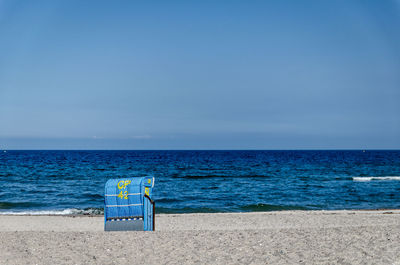 Scenic view of beach against blue sky