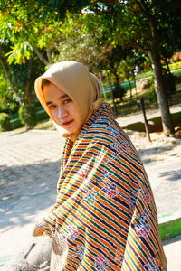 A beautiful girl in a park taking a photo shoot