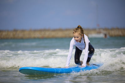 Side view of woman surfing in sea