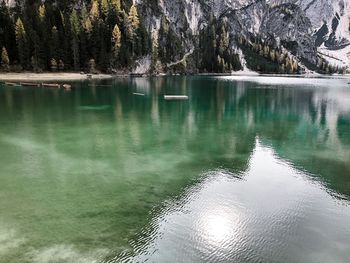 Scenic view of lake by trees against mountain