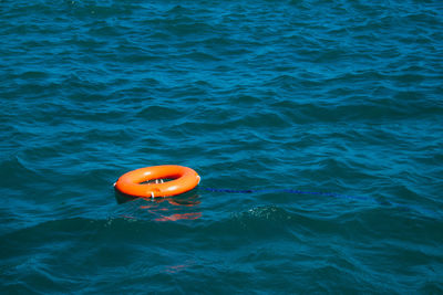 High angle view of life belt floating on sea