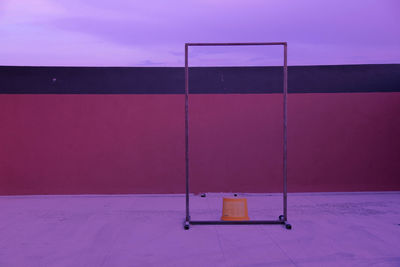 Empty chair against blue sky and building