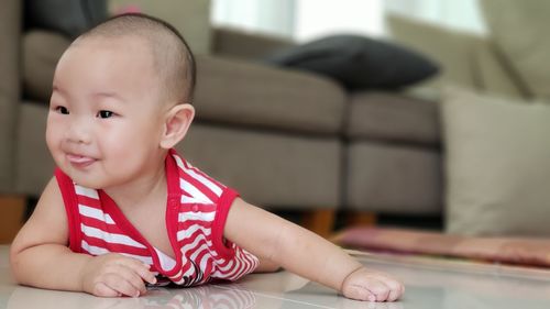Portrait of cute boy sitting at home