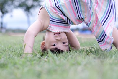 Portrait of cute baby lying on field