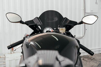 Close-up of motorcycle against wall
