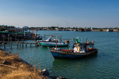 Boats moored at harbor