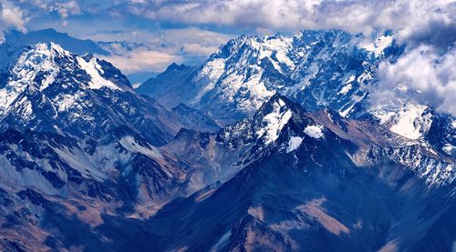 Aerial view of snowcapped mountains against sky