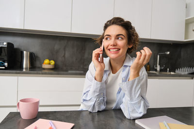 Portrait of young businesswoman working at table