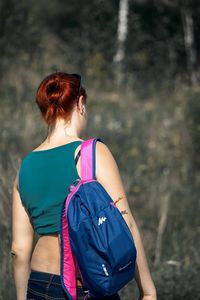 Young woman standing by railing
