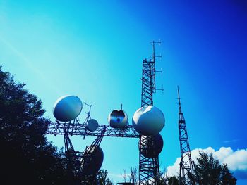 Low angle view of communications tower against clear blue sky