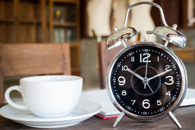 Close-up of clock on table