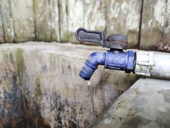 Close-up of faucet against wall