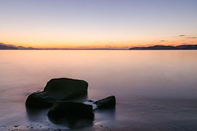 Scenic view of sea against sky at sunset