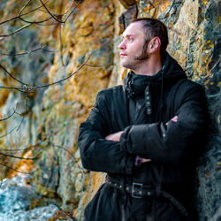 Young man looking away in forest