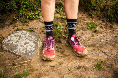 Low section of person standing on rock