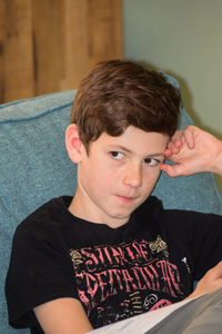 Portrait of boy sitting at home