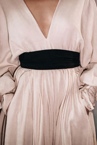 Fashion elegant feminine details of spring summer beige long dresses with black wide belts