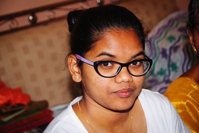 Portrait of woman wearing eyeglasses at home