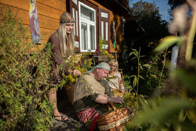 Rear view of woman standing by plants