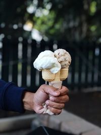 Hand holding ice cream cone