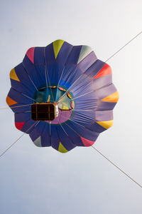 Low angle view of multi colored umbrellas against sky