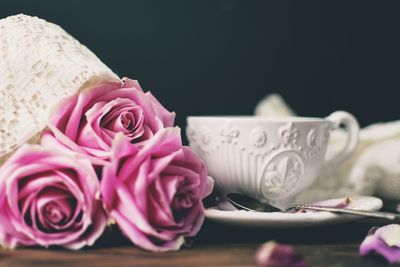 Close-up of rose bouquet and coffee cup on table