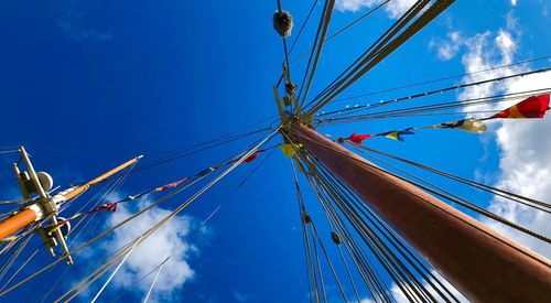 Low angle view of sailboat against blue sky